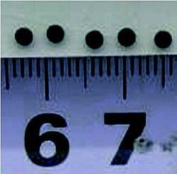 1 mm spots done on a ceramic (the ruler below confirms the spot size).